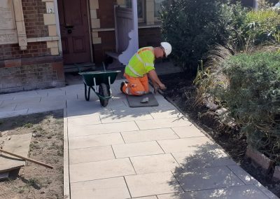 Purbeck stone slabs being laid and pointed in front of Seldown Lodge, providing better access to the terracotta scrolls at the entrance